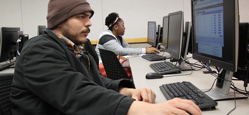 Male student working on a computer