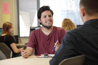student talking to another student